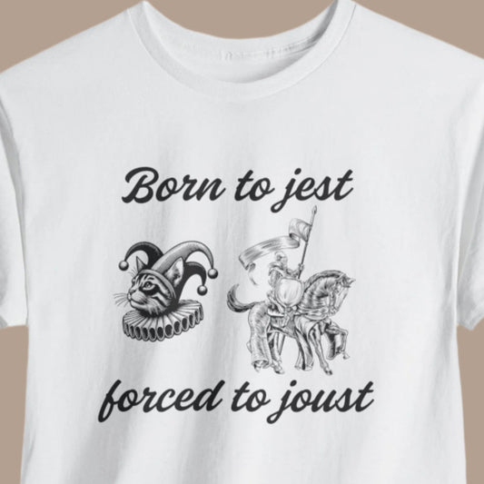 White crew neck t-shirt with the text 'Born to Jest, Forced to Joust' accompanied by a graphic of a unicorn and a knight in armor.