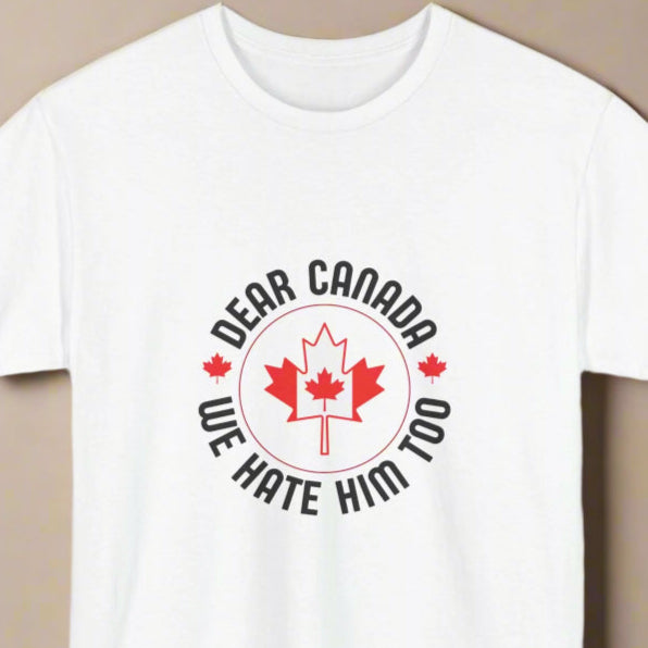 White crew neck t-shirt with the text 'Dear Canada, We Hate Him Too' and a maple leaf design.