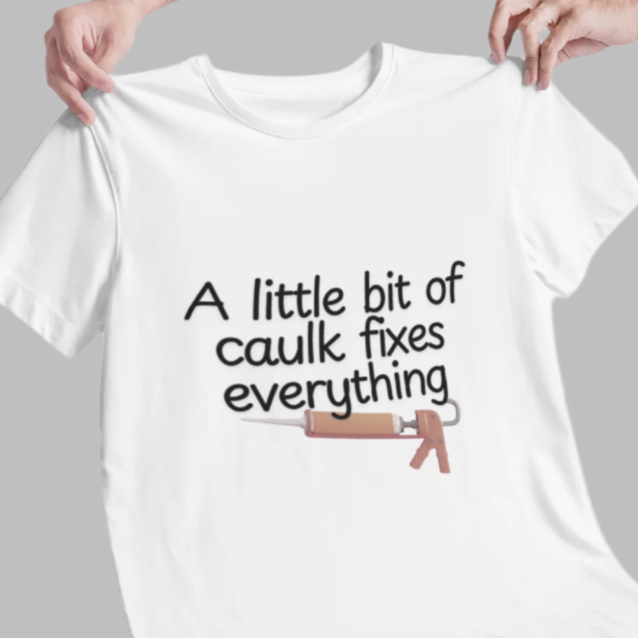 A white men's t-shirt with the text 'A little bit of caulk fixes everything' printed on the front.