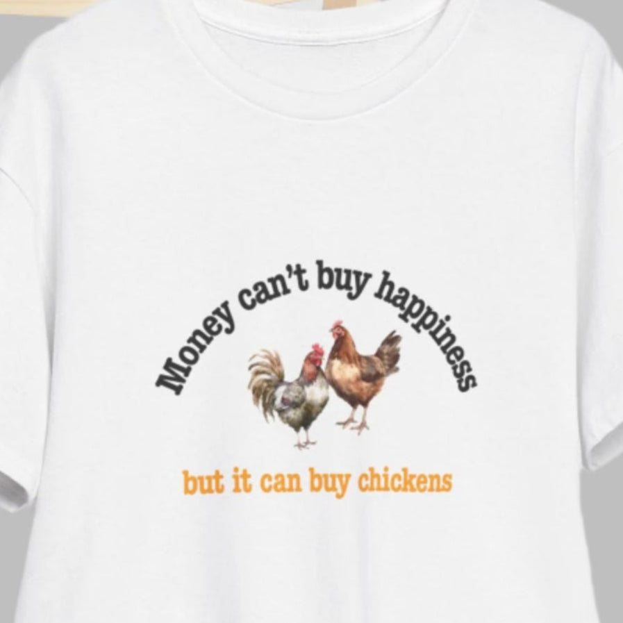 White t-shirt with humorous text and chicken graphics on a wooden chair against a white background